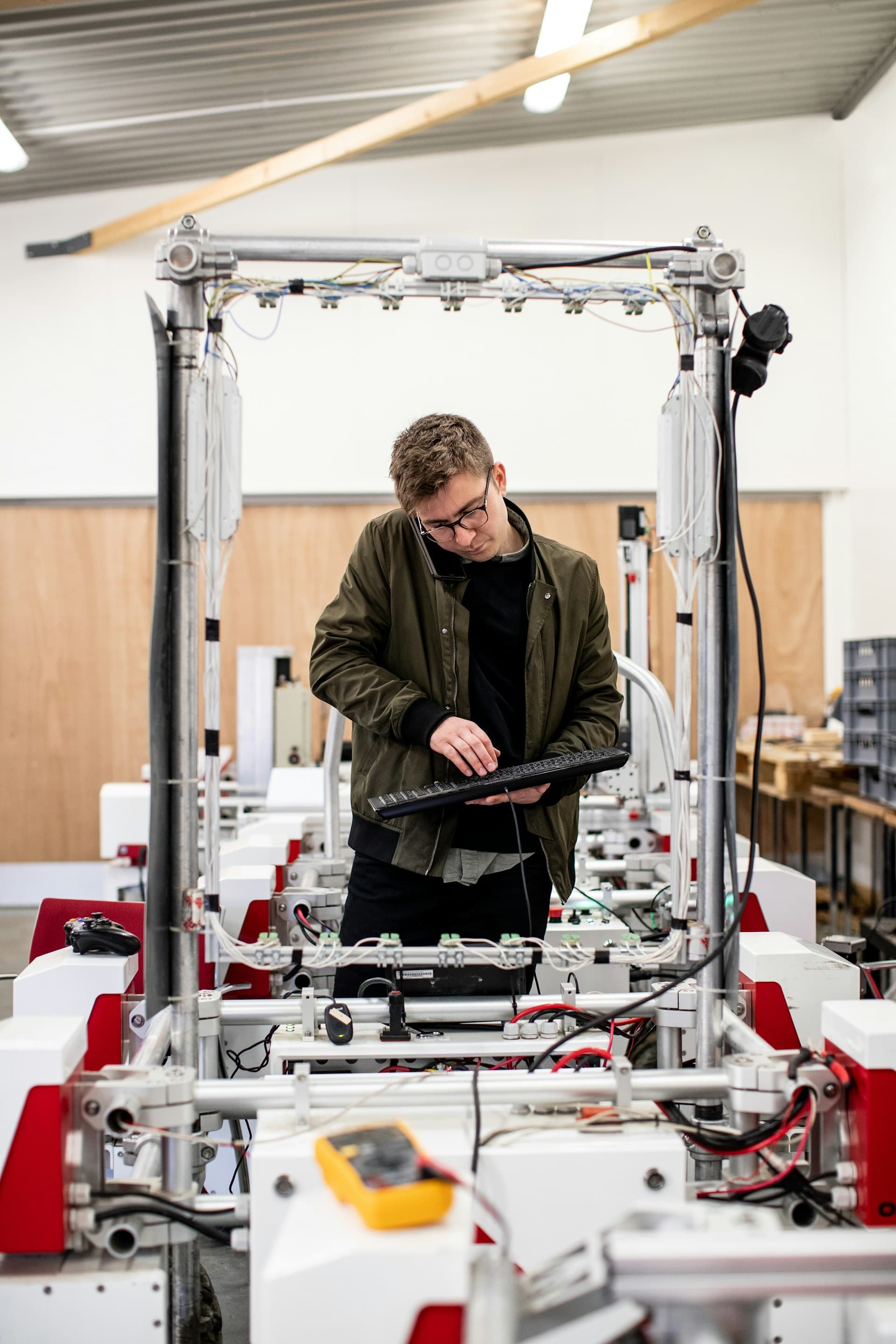 Engineer validating an inspection system with a tablet and multimeter